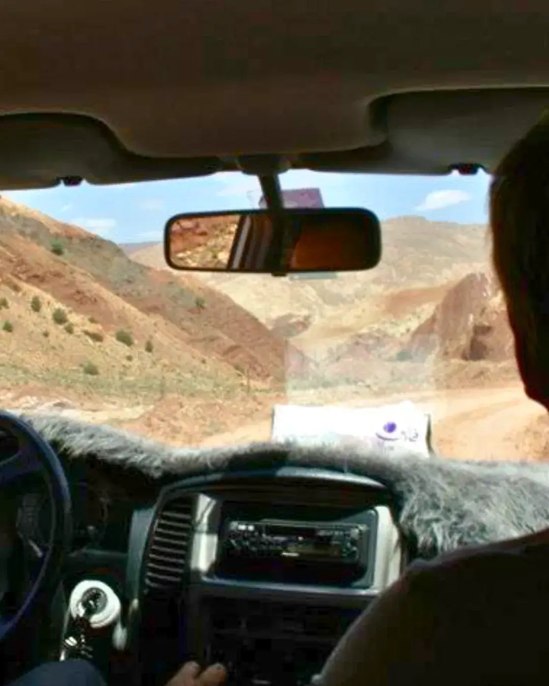 Driving a 4x4 on remote desert road, off-grid self-drive adventure, road trip travel guide visual for Morocco by woopies world