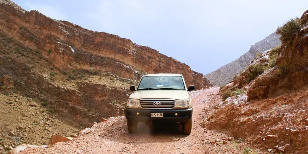 4x4 off-road vehicle on remote dirt trail – solo travel and family road trip blog visual for Woopies World