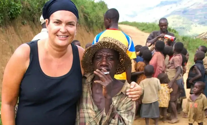 Neeltje smiling with local man during rural village visit in Uganda – real travel moments behind Woopies World