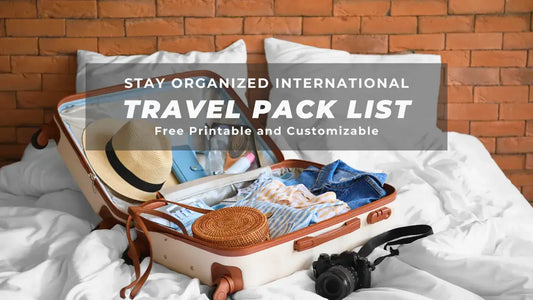 Open suitcase with clothes and camera on bed, promoting printable international travel packing list for organization.