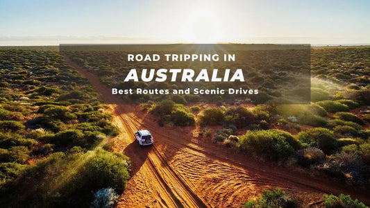 Off-road vehicle driving through an Australian desert landscape, showcasing road trip adventures and scenic routes in Australia.